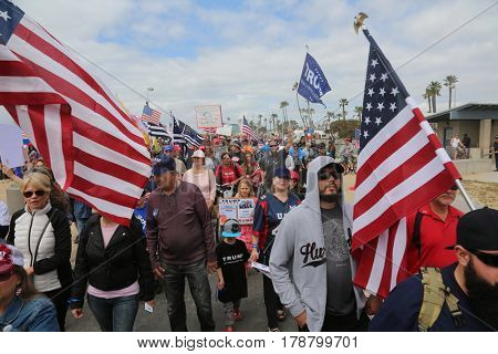 Huntington Beach, CA - March 25 2017: Make America Great Again March. Thousands of Supporters of republican president Donald Trump, wave flags, signs and march at a MAGA March in Huntington Beach. 

