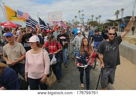 Huntington Beach, CA - March 25 2017: Make America Great Again March. Thousands of Supporters of republican president Donald Trump, wave flags, signs and march at a MAGA March in Huntington Beach. 
