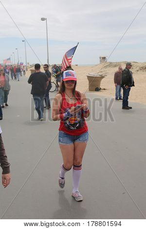 Huntington Beach, CA - March 25 2017: Make America Great Again March. Thousand of Supporters of republican president Donald Trump, wear T-Shirts march and wave flags, at a MAGA March. 





