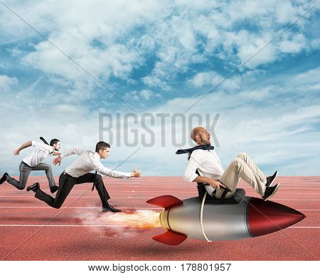Businessman fly with rocket during a race with opponents