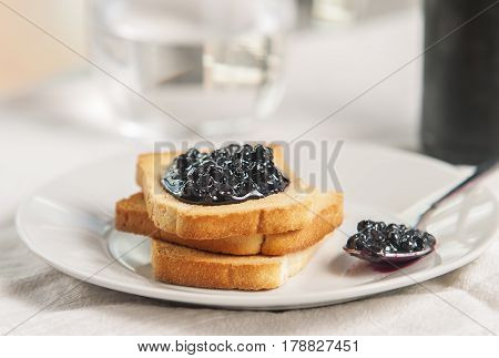 Delicious toast with jam on table close-up