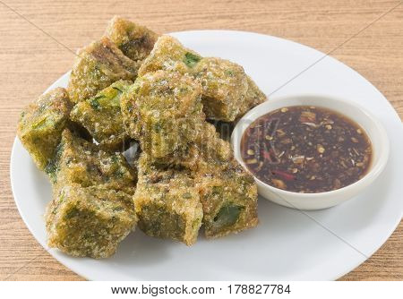 Plate of Fried Chinese Pancake or Fried Steamed Dumpling Made of Garlic Chives Rice Flour and Tapioca Flour Served with Spicy Soy Sauce. Traditional Food of China.