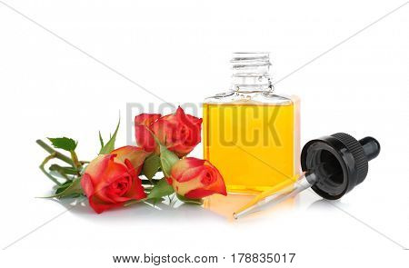 Bottle with perfume oil and rosebuds on white background