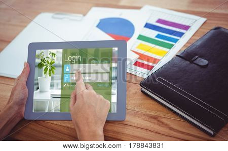 Close-up of login page against over shoulder view of hipster woman using tablet