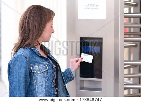 Young Woman Puts The Card Into The Reader System