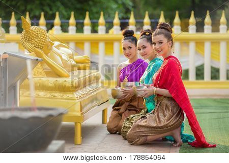 Asian woman to pay respect to Buddha statue in thailand.