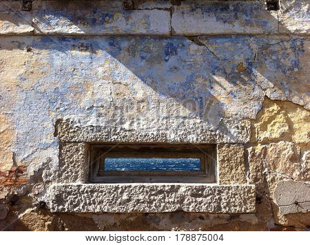 Granite window in old fortification with sea panorama Caprera Island Sardinia Italy