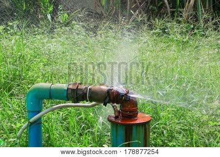 plumbing main tube and water leak old tap pipe steel rust on grass floor