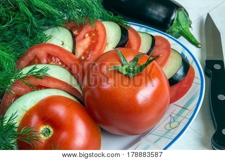 Tomato and aubergine sliced. Fresh dill. Preparation of a vegetable dish ratatouille. Vegetarian.
