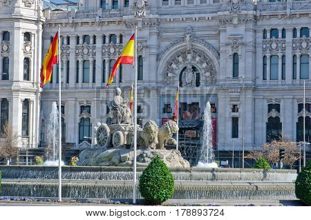 Fountain on Cybele Square (Plaza de Cibeles) with Cybele Palace (Palacio de Cibeles) on background in Madrid Spain