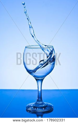 a glass of water on white background.a glass of freezing water