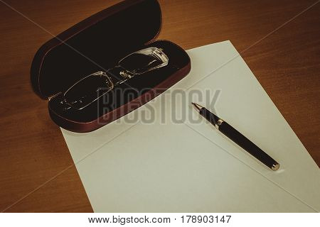 Financial charts pen and glasses.a sheet of white paper