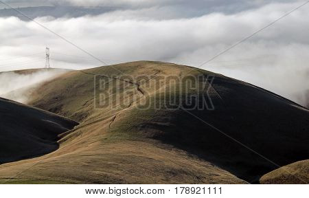 Clouds Covering a Mountain Valley with Rolling Hills at Sunrise