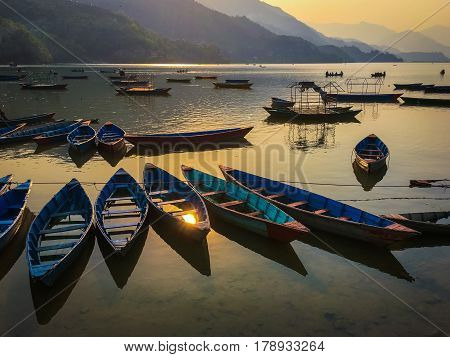 Sunset empty boats scene in the lake Phewa Pohkara Nepal