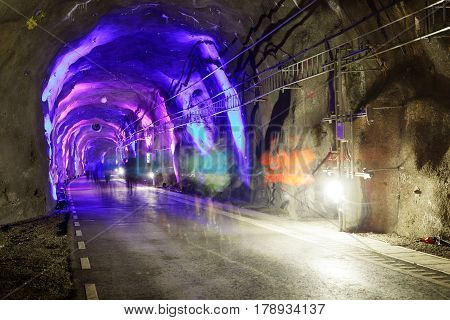 STOCKHOLM SWEDEN - MAR 25 2017: Blue light in tunnel and a group of ghost like runners in the Stockholm Tunnel Run Citybanan 2017. March 25 2017 in Stockholm Sweden