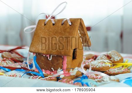 Homemade gingerbread house and decorated gingerbread hearts for wedding and Valentine's day.