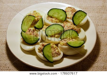 eggs stuffed with liver of cod with slices of cucumber