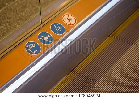 signs on an escalator warning signs the escalator at the mall