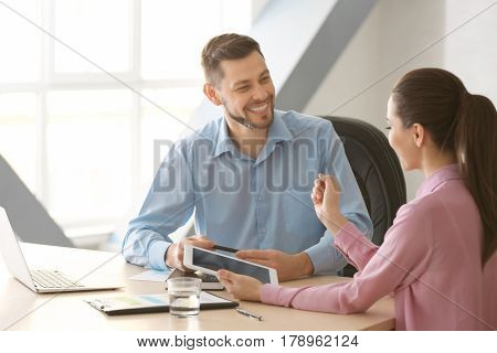 Young managers discussing issues in office