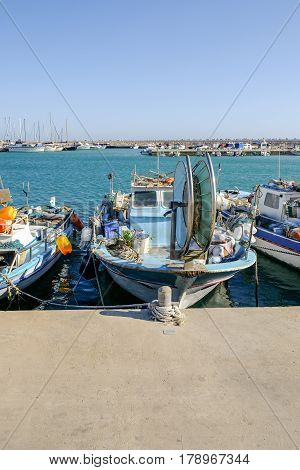Fishing boat moored at Zygi, Cyprus, afternoon shot with blue sky.