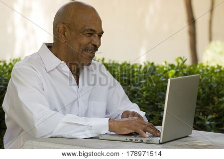 African American senior citizen with laptop computer