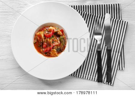 Plate with tasty chicken cacciatore on table
