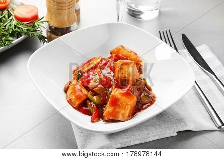 Plate with tasty chicken cacciatore on table