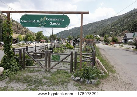 Idaho Springs CO USA - June 24 2016: Beautiful Community Garden Scraps-to-Soil and entry signs at 2225 Miner Street. Scraps-to-Soil Community Garden on a summer day
