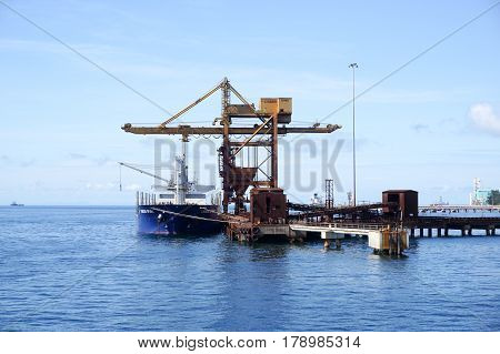 Labuan,Malaysia-Mac 25,2017:A large bulk carrier supplying iron ore in Antara Steel Mill Plant port at Labuan,Malaysia.The company produces billets and bars including angle bars and U-channels.
