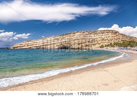 Matala beach and lagoon with sandstone cliffs and turquoise waters of the Libyan Sea near Heraklion in Crete,  Greece, Mediterranean