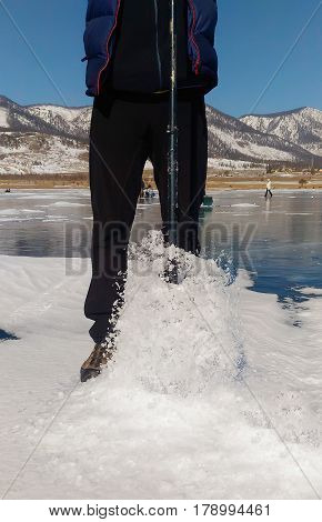 Ice drill and the ice fishing rod.