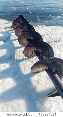 Ice drill and the ice fishing rod.
