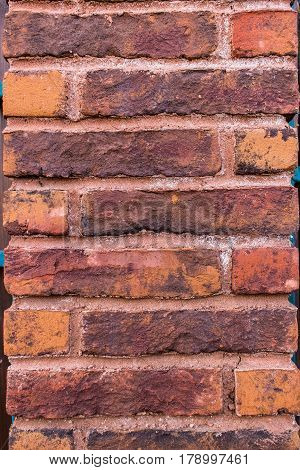 The fragment of red brickwork. Vertical pillar.