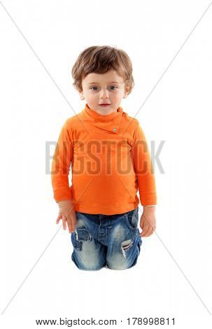 Playful baby on knees with orange jersey isolated on a white background