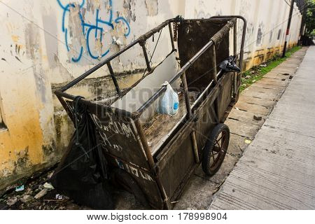 an abandon unmaintained cart for carrying garbage park on side the street photo taken in Jakarta Indonesia java