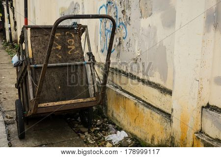 an abandon cart for carrying garbage park on side the street photo taken in Jakarta Indonesia java