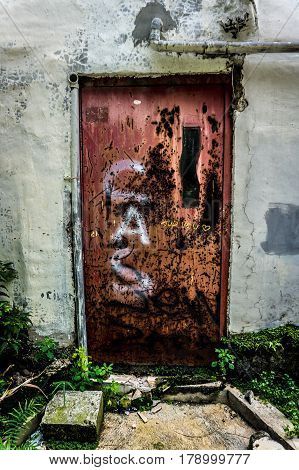 an abandoned old and grunge door with red colour photo taken in Jakarta Indonesia java
