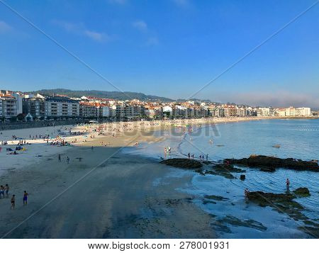 View Of A Typical Beach Day During A Sunny Summer In Sanxenxo Galicia Spain