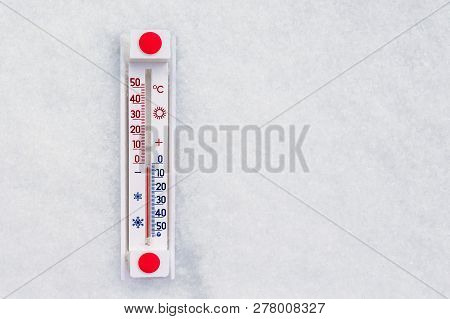 The Thermometer Lies In The Snow And Shows A Subzero Temperature. Weather Forecast. Copy Space