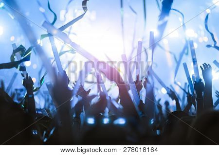 Silhouettes Of Hand In Concert.light From The Stage.