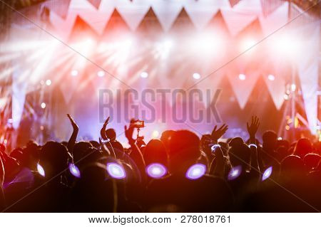 Silhouettes Of Hand In Concert.light From The Stage.