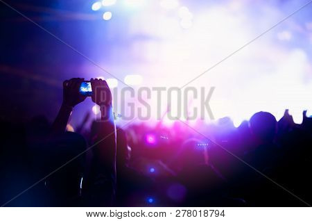 Silhouettes Of Hand In Concert.light From The Stage.