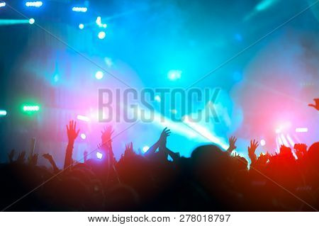 Silhouettes Of Hand In Concert.light From The Stage.