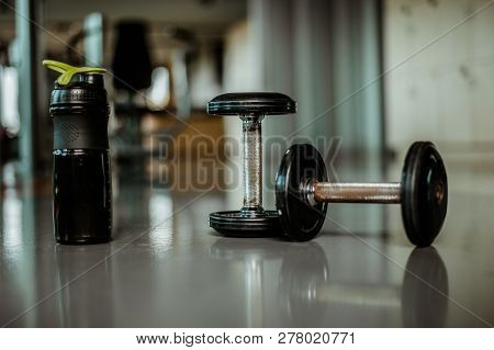 Rows Of Dumbbells In The Gym With Hign Contrast And Monochrome Color Tone.