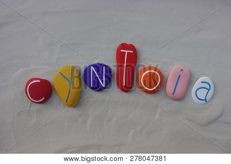 Cyntoia, Feminine Given Name Celebrated With A Composition Of Colored Sea Stones Over White Sand