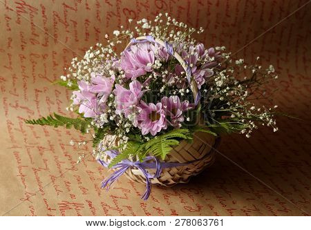 Cute Flower Arrangement In A Straw Basket.