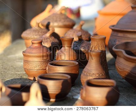 Several Clay Pots In The Sunset Light
