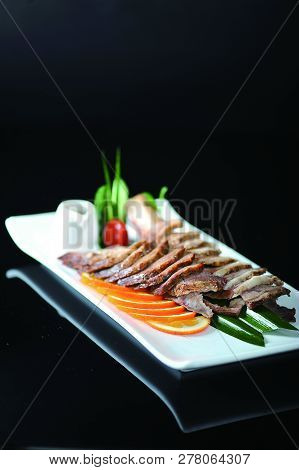Sauce Char Siew Slices In A White Dish
