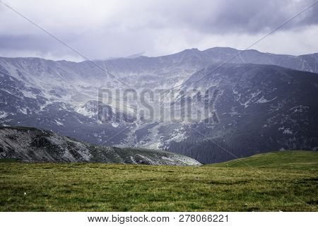 Landscape With Mountains, Green Hills And Cloudy Sky, Transalpina Road, Romania.