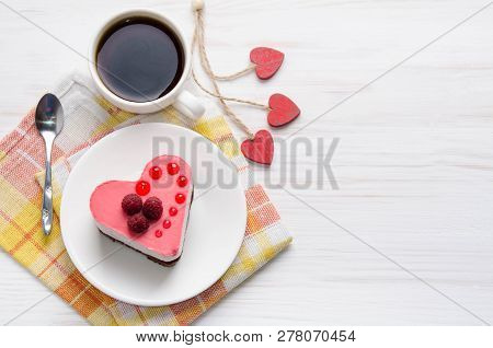 Souffle Cake In The Form Of Heart  With Cup Of Coffee On A Wooden Table